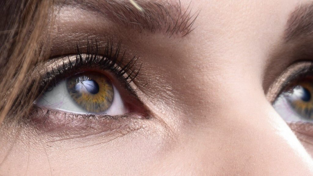 A close-up image focusing on the eyes of a person's face and a healthy skin which is the result of the benefits of fitness for your skin.