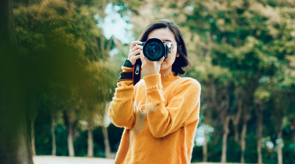 A woman with a camera ready to take a photo